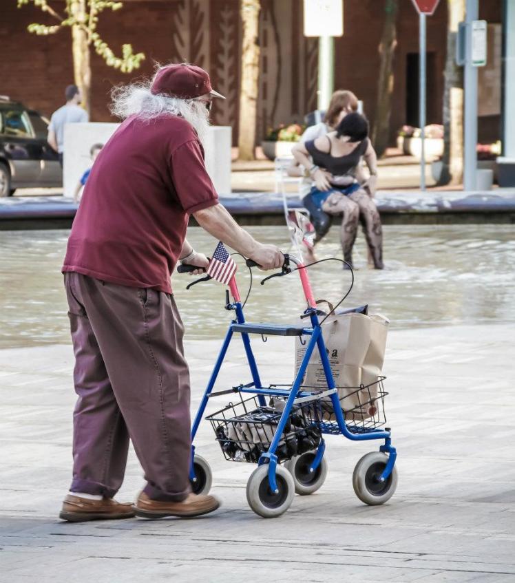 guy with a walker rolls by the lovebirds by AB
